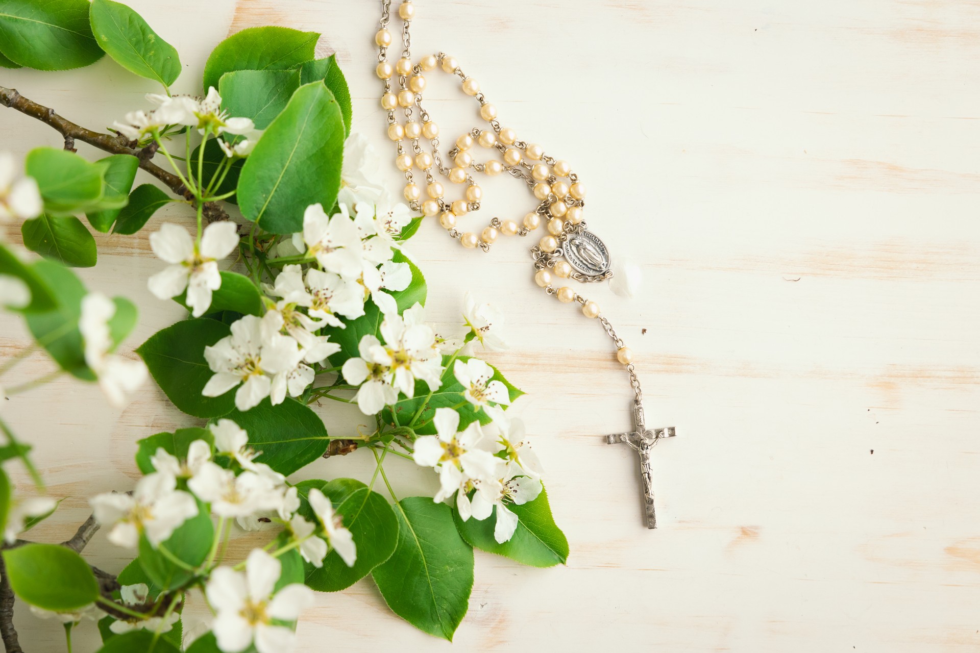 Rosary and white flower blossoms